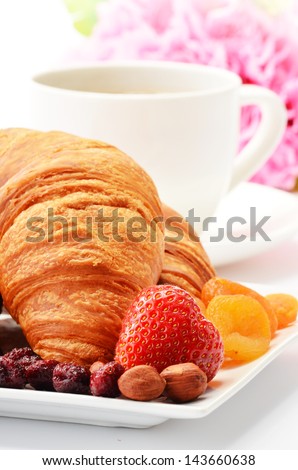 Breakfast with croissants, cup of coffee and fruits