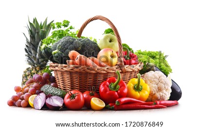 Assorted organic vegetables and fruits in wicker basket isolated on white background. 商業照片 © 