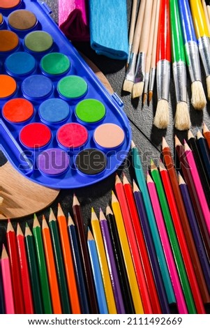 Composition with school accessories for painting and drawing.