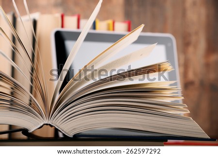 Composition with books and tablet computer on the table.