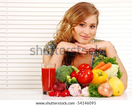 Beautiful young woman and vegetables on the table