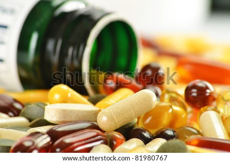 Composition with nutritional supplement capsules and containers. Variety of drug pills