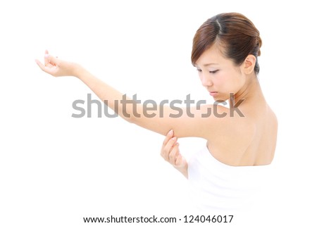 young woman checking her upper arm