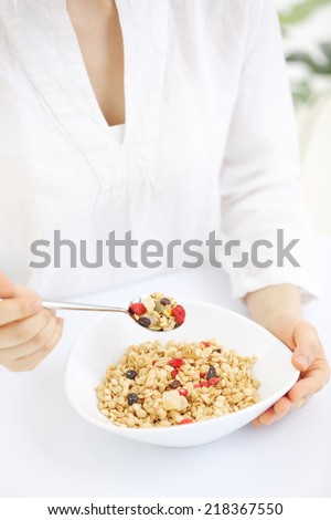 young woman eating cereals