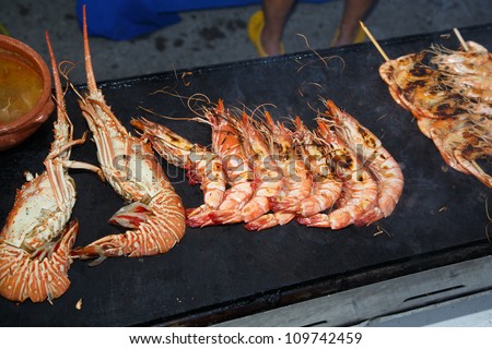 OLHAO, PORTUGAL - AUG 8:  Workers cooking seafood at seafood event on August 8, 2012 in Olhao, Portugal.