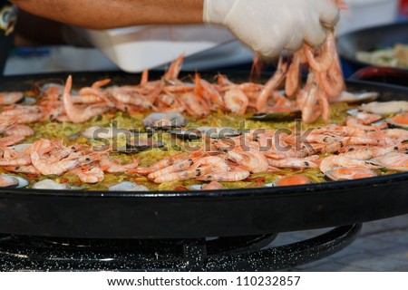 OLHAO, PORTUGAL - AUG 11: Workers cooking seafood at seafood event on August 11, 2012 in Olhao, Portugal.