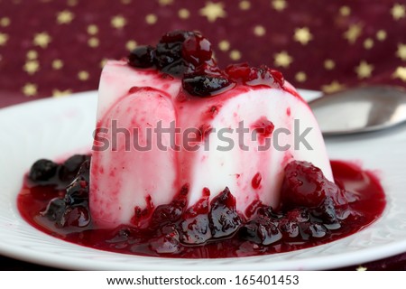 slice of milk coconut cake with red fruits syrup