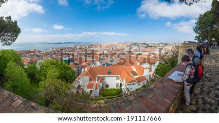 LISBON, PORTUGAL - APRIL 18, 2014: tourists sightseeing in Sao Jorge Castle with a view over the city of Lisbon, Portugal.