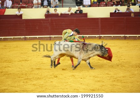 LISBON - JUNE 19: Jose Garrido bullfighter performs at a portuguese style bullfighting show in campo pequeno in Lisbon, Portugal, June 19, 2014