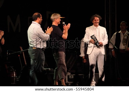 LOULE, PORTUGAL - JUNE 24: Goran Bregovic and His Wedding  Funeral Band receive Song lines world music award onstage at Festival Med June 24, 2010 in Loule, Portugal.