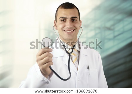 Smiling medical doctor with stethoscope on the hospitals background