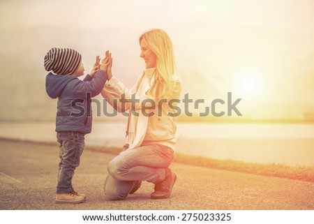 Happiness mother and son under sun light