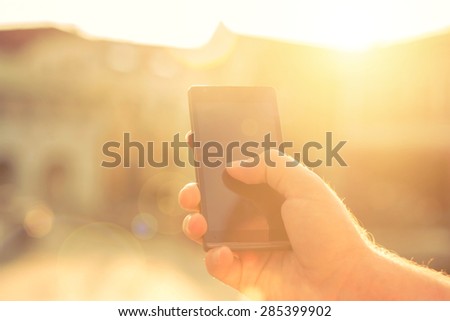 Man with telephone under sunlight