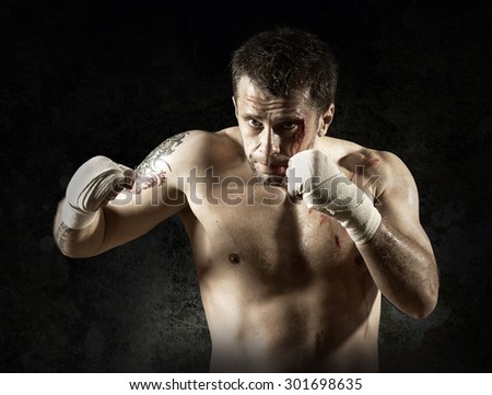 Portrait of aggressiv boxer in blood