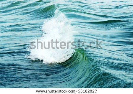 Big green wave breaks in ocean