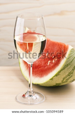 cup serving of watermelon with white wine, on wood base