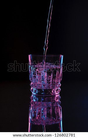 Rocks Glass Tumbler Cocktail Glass Filling up Pouring Water or Liquid, Dark Field, Color Gels Lighting