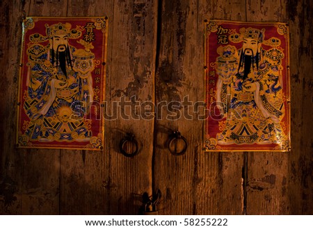 Old wooden door with Chinese door-gods on
