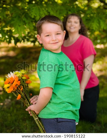 Little boy giving flowers to his mom on mother's day
