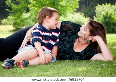 Mother and son play outside on field on Mother\'s Day.