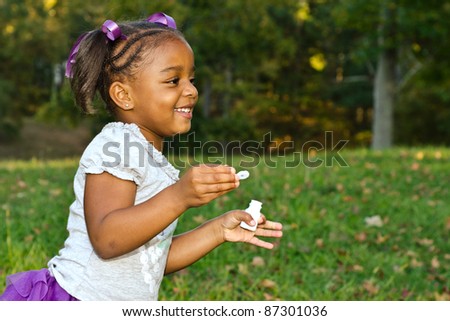 Young African-American girl playing in park