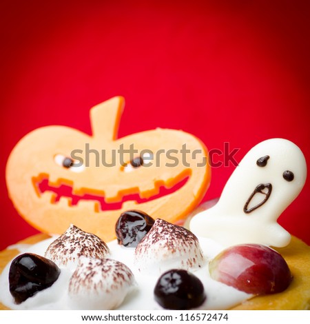 Halloween cake with pumpkin red background