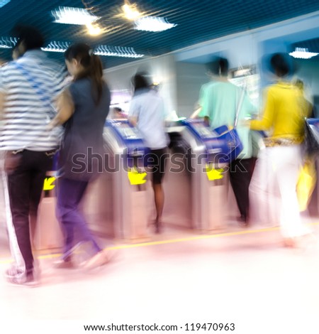 people enter or check out subway station, motion blurred