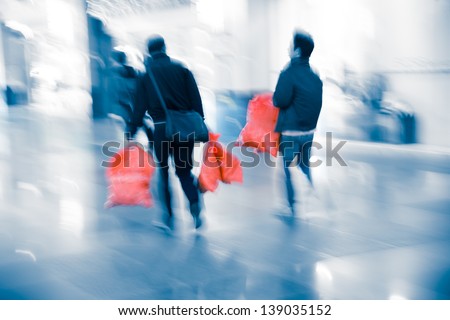 city business people shopping inside a mall with bag, blur motion