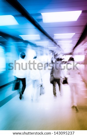 abstract business people crowd walk at subway station blurred motion