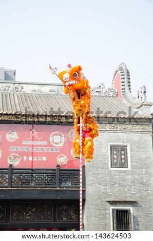 FOSHAN,CHINA- FEB. 19: Chinese Lion dance perform. Lion dance is a form of traditional dance in Chinese,in which performers mimic a lion\'s movements in a lion costume.  Foshan, Feb. 19, 2012.