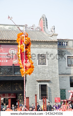 FOSHAN,CHINA- FEB. 19: Chinese Lion dance perform. Lion dance is a form of traditional dance in Chinese,in which performers mimic a lion's movements in a lion costume.  Foshan, Feb. 19, 2012.
