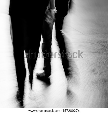 abstract business people walking on city street, black and white motion blurred.