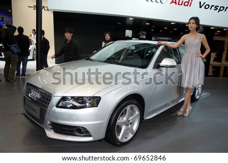 GUANGZHOU, CHINA - DEC 27: Fashion Model on Audi A4L car at the 8th China international automobile exhibition on December 27, 2010 in Guangzhou China.