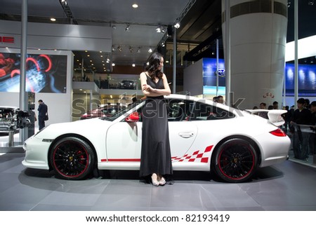 GUANGZHOU, CHINA - DEC 27: Fashion Model on Porsche 911 car at the 8th China international automobile exhibition on December 27, 2010 in Guangzhou China.