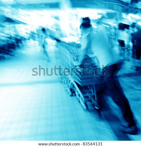 city crowd people with shopping cart blur motion