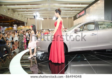 GUANGZHOU, CHINA - OCT 02: Fashion model with Qilin car at the Guangzhou daily Baiyun international automobile exhibition on October 02, 2011 in Guangzhou China.