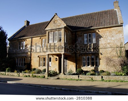 Winter sunshine on a Natural Stone Mullion windowed English Village Manor House