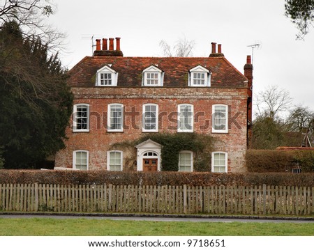 English Georgian Manor House with Picket Fence and Beech hedge to the front