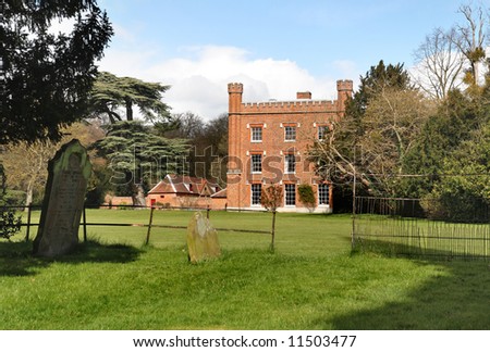 An English Country Mansion and Gardens viewed from a Churchyard