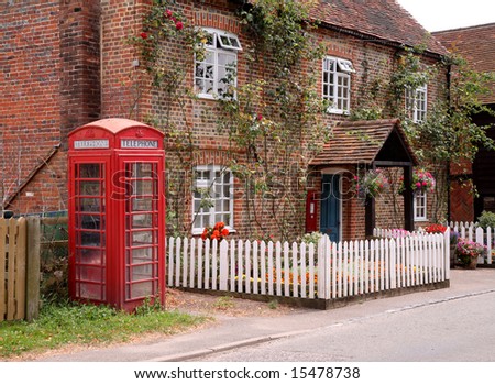 Traditional English Village Post Office with garden, picket fence and telephone Box