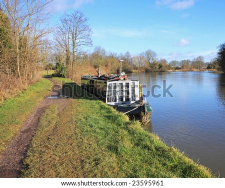 Narrow-boat moored on the banks of the River Thames England