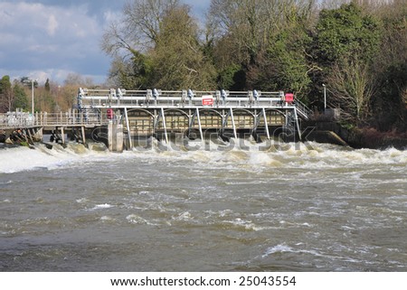 Flood waters passing through a Weir on the River Thames in England