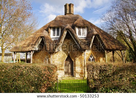 Quirky English Thatched Cottage with Hedgerow to the front