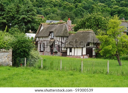 Traditional Timber Framed  and Thatched Norman Village Cottage with meadow to the front
