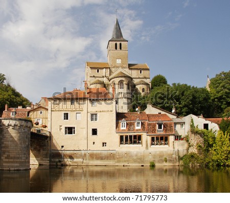 Medieval houses and Church on the banks of a river in Rural France