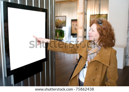 Redhead woman points to picture