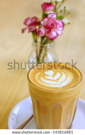 Cup of art latte or cappuccino coffee with flower