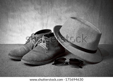 set of men\'s accessory, boots, panama hat and sunglasses