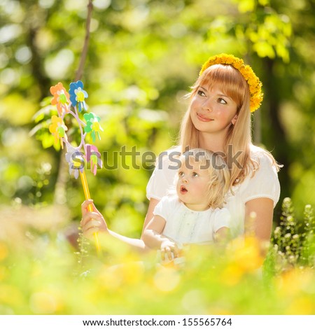 Happy mother and daughter playing in the park
