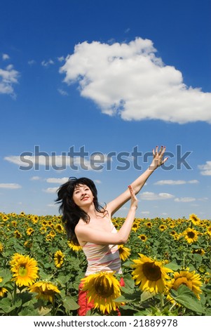 fun woman in the field of sunflowers